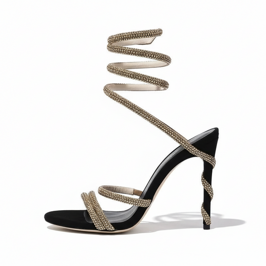 Black high-heeled shoes with gold strappy details 