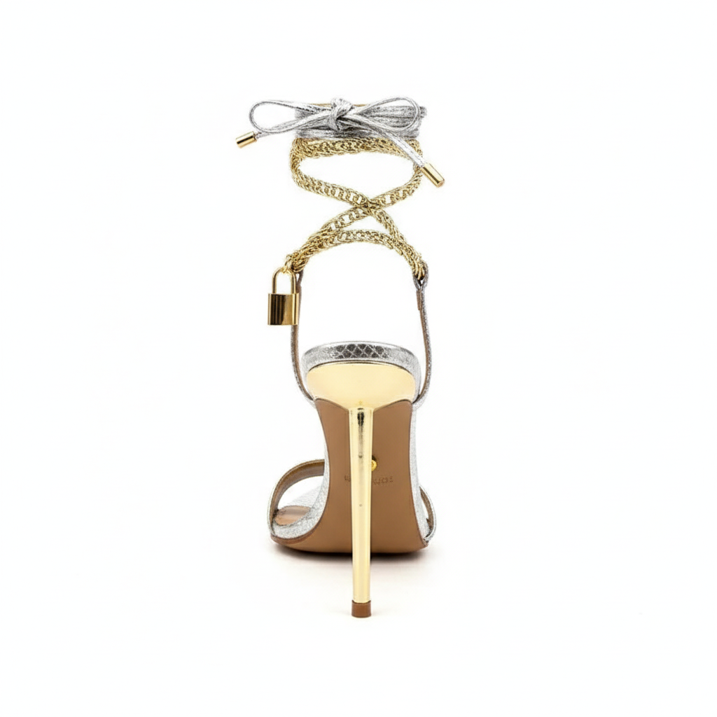 Silver high-heeled sandals with gold accents.