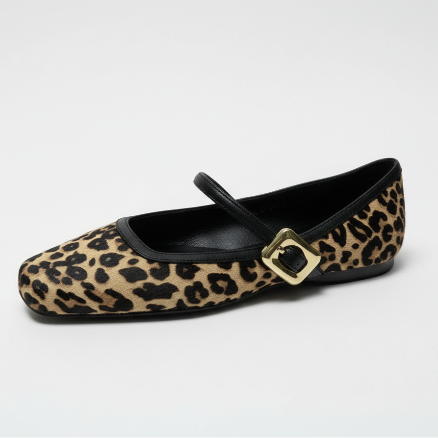 Leopard print flat shoe with a gold buckle on a white surface and light green background