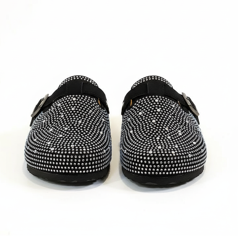 Black clogs with white embellishments 